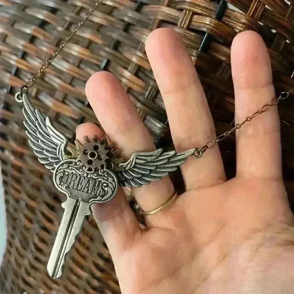 Steampunk Articulating dreams key and wings necklace with mixed metals